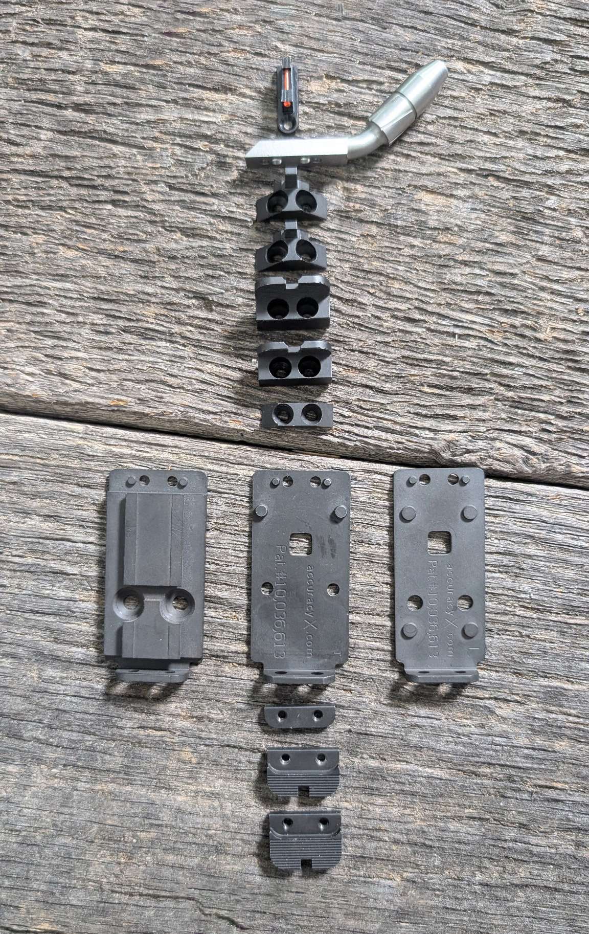 Accuracy X Multi-Sight MAX mounting plates, risers and interchangeable sight blades laid out on weathered wood