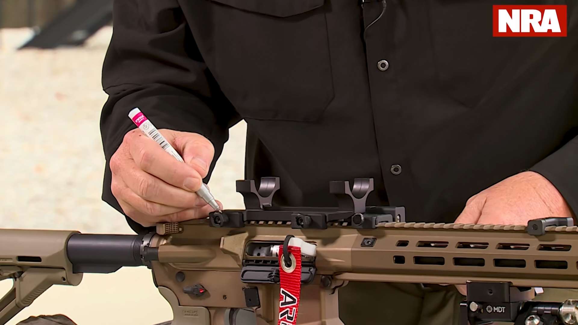 Bubble levels on Picatinny rail and riflescope during leveling process in Kyle Lamb NRA America's Rifle Challenge optics mounting tutorial