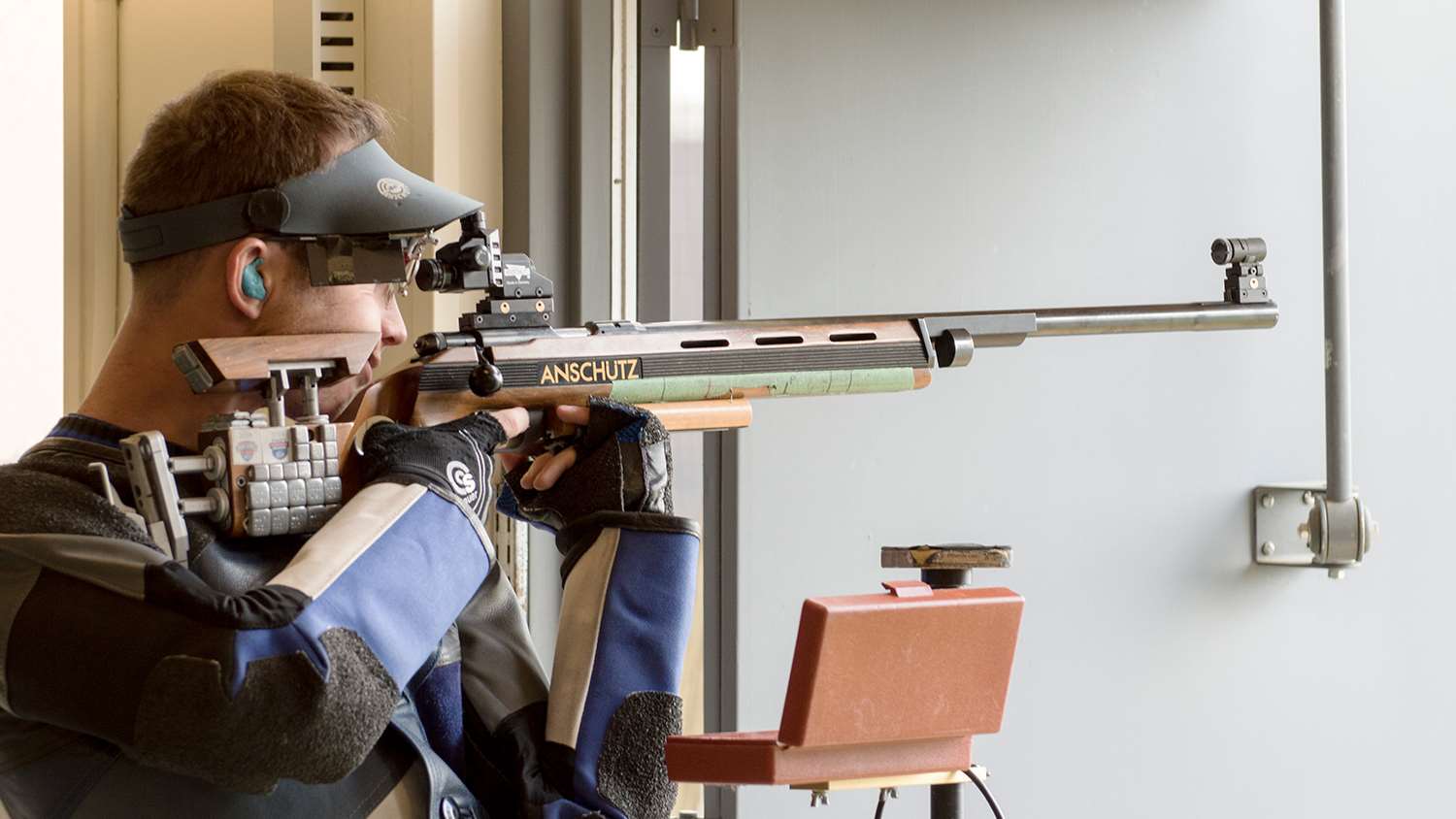 Collegiate rifle shooter displaying trigger technique
