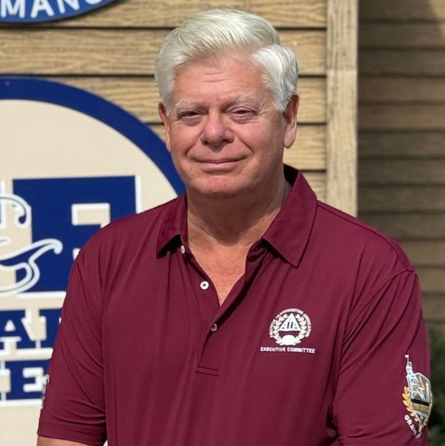 Close-up portrait of Lynn Gipson wearing a maroon ATA Executive Committee polo shirt