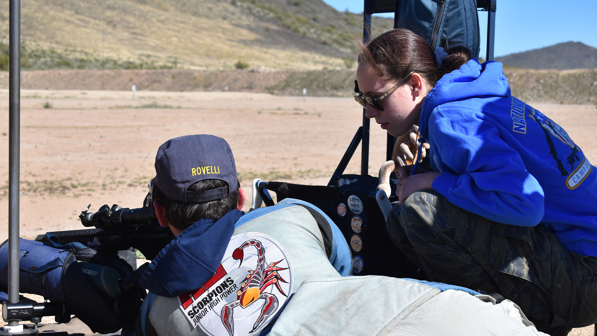 Madison Rovelli coaching a rifle student in Arizona