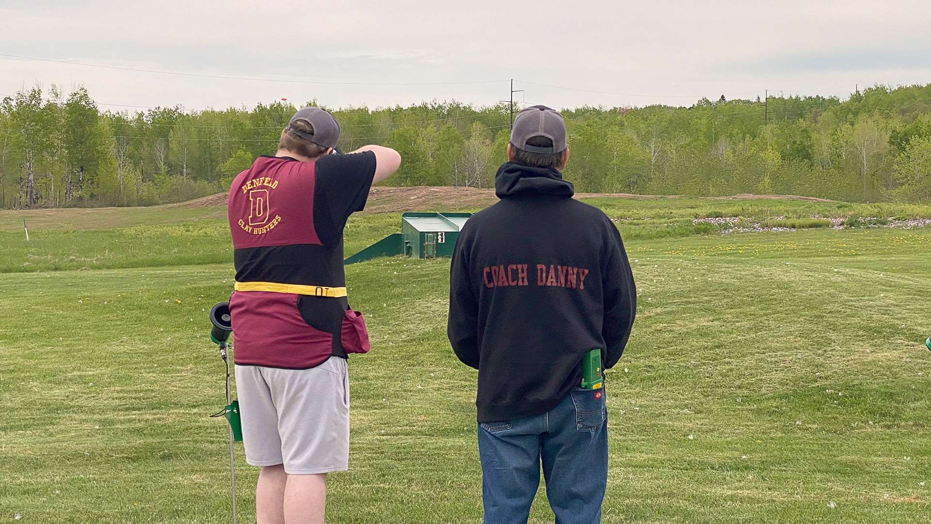 Parker Resnch with his coach on trap field