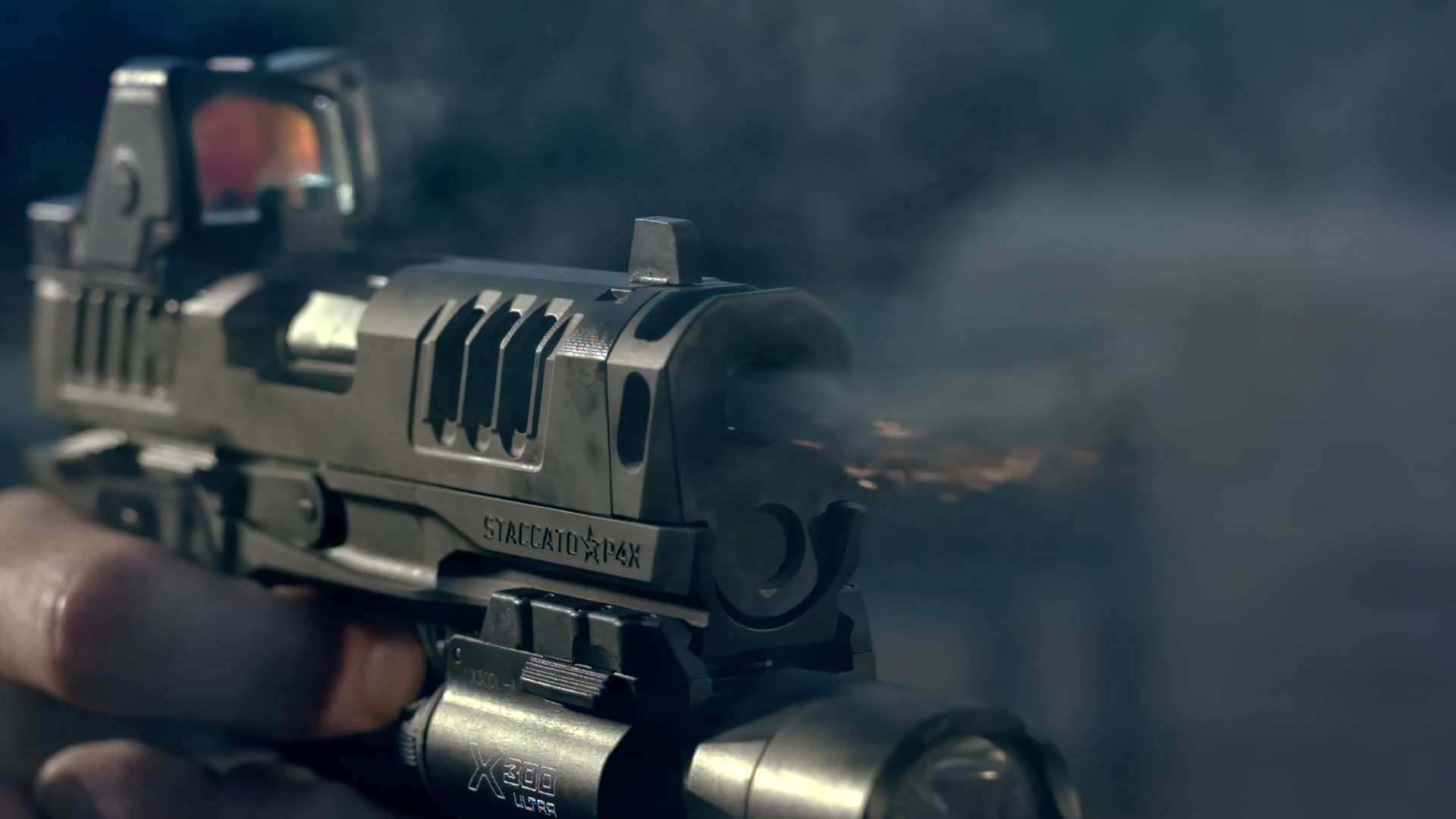 Close-up of the Staccato HD P4X firing with visible gas escaping the integral compensator, equipped with a red-dot optic and light