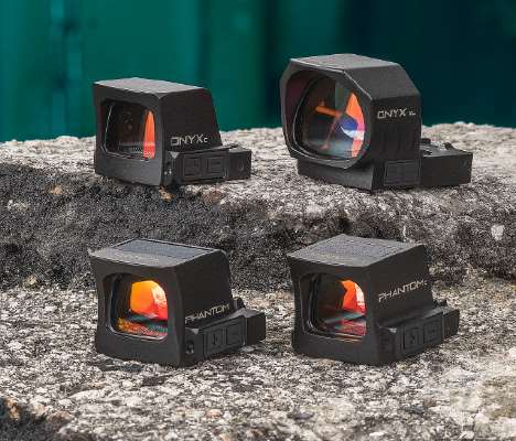 Four black Canik red dot sights arranged in two rows on a rough concrete step.