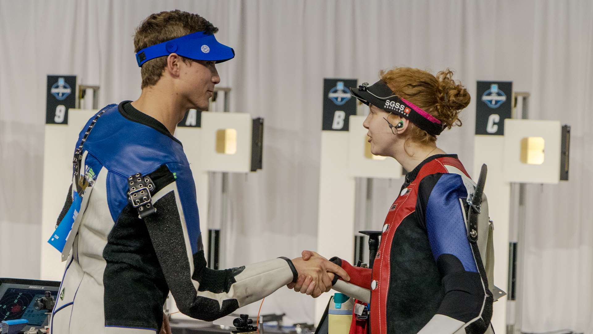Ole Miss shooter Audrey Gogniat and Kentucky shooter Braden Peiser shake hands after the 2025 NCAA air rifle individual championship final at Memorial Coliseum in Lexington Kentucky